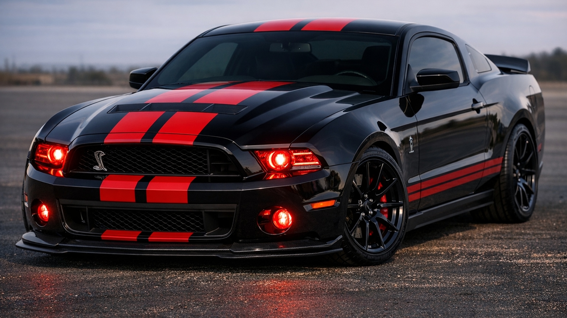 Black Shelby GT 500 with red racing stripes, dark tinted windows and red headlights 