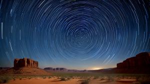 Star trails above the desert timelapse photo