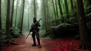 guy with weapon in the forest