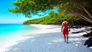 A white beach with one man on it