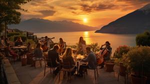 large balcony with family and friends eating food and enjoying traditional music being played by a  stringed quartet. Lake Garda in the background with high mountains at sunset.