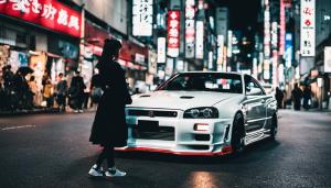 Nissan r34 in tokyo at night with a girl