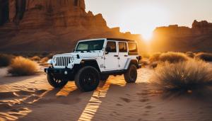 A Jeep Wranger 4 door, white in color in the desert at sunset