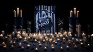 Mourning for Kay Bernstein with a Picture of him and the Hertha BSC logo with candles. In a sad atmosphere, with beautiful shadows, with dark colors in almost black and white. With the reference to football and the east curve of Hertha BSC. Breathtakingly presented.