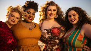 Curvy models at sunset beach party
