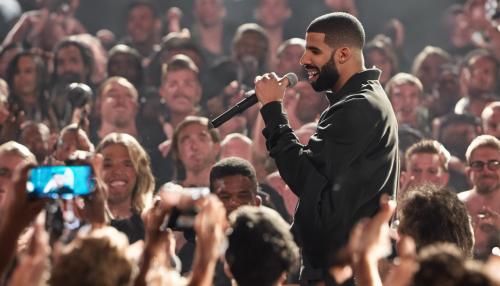 drake on stage in front of a crowd