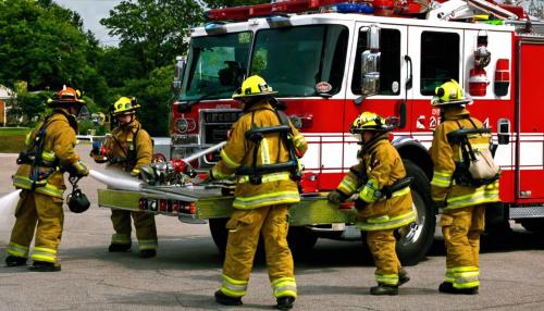 Firefighters in front of fire engine